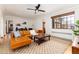 Bright living room featuring a leather sectional, hardwood floors, a modern rug, and natural light at 1419 Dexter St, Denver, CO 80220