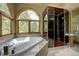 Luxurious bathroom with a soaking tub, large windows, and steam shower at 2191 Baldy Ln, Evergreen, CO 80439