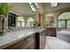 Elegant bathroom with a double vanity, granite countertops, and large windows at 2191 Baldy Ln, Evergreen, CO 80439