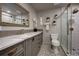 Elegant bathroom featuring a marble vanity, gold fixtures, and a glass-enclosed shower with decorative tiling at 2191 Baldy Ln, Evergreen, CO 80439