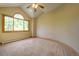 Sun-lit bedroom features a vaulted ceiling, carpet, and large windows with tree views at 2191 Baldy Ln, Evergreen, CO 80439