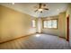 Comfortable bedroom with neutral carpet, a ceiling fan, and generous natural light from well-placed windows at 2191 Baldy Ln, Evergreen, CO 80439