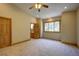 Spacious bedroom featuring neutral walls, a ceiling fan, and natural light from the window at 2191 Baldy Ln, Evergreen, CO 80439