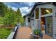 Lovely deck with blue flowers overlooks lush greenery, providing a serene outdoor space at 2191 Baldy Ln, Evergreen, CO 80439