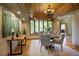 Bright dining room features a beautiful bay window, chandelier, and stylish furnishings at 2191 Baldy Ln, Evergreen, CO 80439