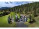 Expansive home featuring a multi-car garage, set against a backdrop of lush trees and mountain views at 2191 Baldy Ln, Evergreen, CO 80439