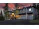 Grand two-story home with stone accents, a circular driveway, and a beautifully landscaped yard at 2191 Baldy Ln, Evergreen, CO 80439