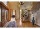 Luxurious foyer with hardwood floors, chandelier, staircase, and a glimpse of a home office at 2191 Baldy Ln, Evergreen, CO 80439