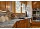 Kitchen features granite countertops, stainless steel appliances, and beautiful backsplash at 2191 Baldy Ln, Evergreen, CO 80439