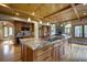 Gourmet kitchen with granite countertops, wood cabinetry, modern appliances, and stone fireplace at 2191 Baldy Ln, Evergreen, CO 80439