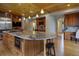Gourmet kitchen with a large island, granite countertops, wood cabinetry, and modern appliances at 2191 Baldy Ln, Evergreen, CO 80439