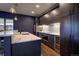 Chic kitchen boasts custom cabinetry, marble countertops, stainless steel appliances and an elegant wine refrigerator at 2191 Baldy Ln, Evergreen, CO 80439