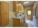 Functional laundry room with wood cabinets, sink, washer, dryer, and convenient access to an outdoor door at 2191 Baldy Ln, Evergreen, CO 80439