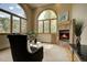 Cozy living room showcasing large windows, fireplace, and comfortable seating at 2191 Baldy Ln, Evergreen, CO 80439