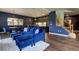 Stylish living area with blue accents, hardwood floors, and an open layout to the kitchen at 2191 Baldy Ln, Evergreen, CO 80439