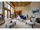Bright living room with a comfortable blue sofa, stylish furnishings, and beautiful view at 2191 Baldy Ln, Evergreen, CO 80439