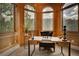 Charming office space with paneled walls, large windows, and elegant decor at 2191 Baldy Ln, Evergreen, CO 80439