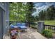 Inviting outdoor deck with comfortable seating and beautiful views of the surrounding trees at 2191 Baldy Ln, Evergreen, CO 80439