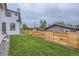 Spacious backyard with a well-maintained lawn and a wooden fence, ideal for outdoor activities at 3019 Chase St, Wheat Ridge, CO 80214