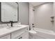 Stylish bathroom featuring modern fixtures, subway tile shower, and a framed mirror creates a clean and functional space at 3019 Chase St, Wheat Ridge, CO 80214