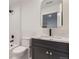 Clean bathroom with white subway tile, a sleek black faucet, and a framed mirror provides modern and functional design at 3019 Chase St, Wheat Ridge, CO 80214