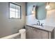 Contemporary bathroom with modern lighting, stylish mirror, and speckled floors provides a chic and updated design at 3019 Chase St, Wheat Ridge, CO 80214