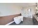 Spa-like bathroom featuring a freestanding tub, elegant vanity, and modern fixtures at 3019 Chase St, Wheat Ridge, CO 80214