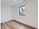 Bright and airy bedroom with a large window, hardwood floors and neutral color scheme offering modern and comfortable living space at 3019 Chase St, Wheat Ridge, CO 80214