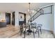 Elegant dining room area with stylish lighting and a modern staircase at 3019 Chase St, Wheat Ridge, CO 80214