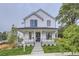 Charming two-story home featuring a covered front porch and manicured lawn, a welcoming facade at 3019 Chase St, Wheat Ridge, CO 80214