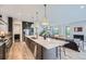 Open-concept kitchen showcasing a spacious island, modern appliances, and seamless flow to the living area at 3019 Chase St, Wheat Ridge, CO 80214