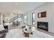 Bright living room with fireplace, hardwood floors, and staircase, offering a cozy and stylish space at 3019 Chase St, Wheat Ridge, CO 80214