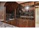 Basement wet bar with decorative horse tile and marble countertops at 13493 E Dakota Ave, Aurora, CO 80012