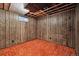 Unfinished basement with wood paneling and small window for natural light at 13493 E Dakota Ave, Aurora, CO 80012