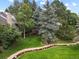 Serene backyard featuring a gentle stream with rocks, a well-maintained lawn, and mature trees at 4505 S Yosemite St # 433, Denver, CO 80237