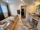 A bathroom with a soaking tub, windows, and gray accent wall at 4505 S Yosemite St # 433, Denver, CO 80237
