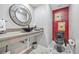 Stylish half bathroom features a modern vessel sink and vibrant red accent wall at 4505 S Yosemite St # 433, Denver, CO 80237
