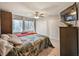 Bedroom with a large bed, two closets, and a large window at 4505 S Yosemite St # 433, Denver, CO 80237