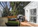 Cozy deck area with outdoor seating, grill, and view of mature trees at 4505 S Yosemite St # 433, Denver, CO 80237
