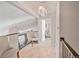 Bright hallway features updated flooring, modern light fixture, and view to lower level at 4505 S Yosemite St # 433, Denver, CO 80237