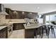 Modern kitchen features dark cabinetry, sleek countertops, and a central island at 4505 S Yosemite St # 433, Denver, CO 80237