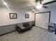 A cozy living room with tile floors, a ceiling fan, and a comfortable grey futon sofa at 4505 S Yosemite St # 433, Denver, CO 80237