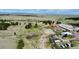 Aerial shot featuring a horse arena, multiple outbuildings, and lush green pasture at 1740 Michael Gates Dr, Parker, CO 80138