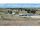 Expansive property with horse facilities, including a large barn and riding arena, surrounded by rolling hills at 1740 Michael Gates Dr, Parker, CO 80138