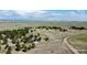 Wide aerial view of a home on sprawling grasslands with scattered trees at 1740 Michael Gates Dr, Parker, CO 80138