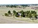 Aerial view of a home on a large property featuring trees and open fields at 1740 Michael Gates Dr, Parker, CO 80138