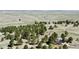 Expansive aerial view showcasing a home nestled among trees in a serene, open landscape with distant mountain views at 1740 Michael Gates Dr, Parker, CO 80138