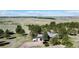 Aerial shot of a secluded home nestled among trees in a vast, open landscape with rolling hills at 1740 Michael Gates Dr, Parker, CO 80138