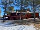 Back of house with a wooden deck and snow on the ground in winter at 1740 Michael Gates Dr, Parker, CO 80138