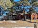 Exterior view of a home surrounded by mature trees and a metal fence at 1740 Michael Gates Dr, Parker, CO 80138